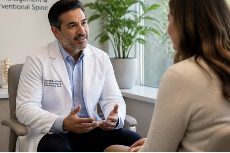 A compassionate specialist at Ramos Center explaining the procedure and benefits of a sympathetic plexus block to a patient in a comfortable clinical setting.